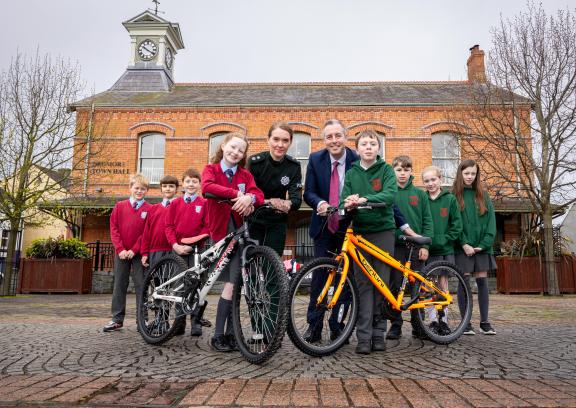 Pictured with two of the refurbished bikes are (from left) St Colman's PS pupils Eoin, Amanda, Arthur and Lily with Chief Superintendent Kellie McMillan and Education Minister Paul Givan also Jake A, Jake T, Isla and Laila from Dromore Central PS.