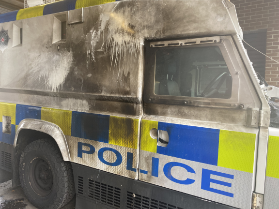 The damaged Land Rover after it was struck with petrol bombs
