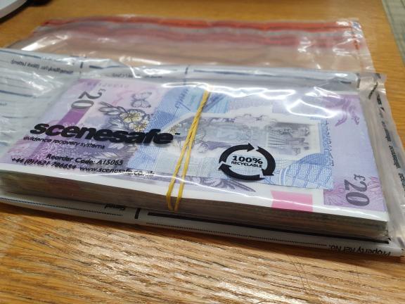 A quantity of cash seized during the searches.