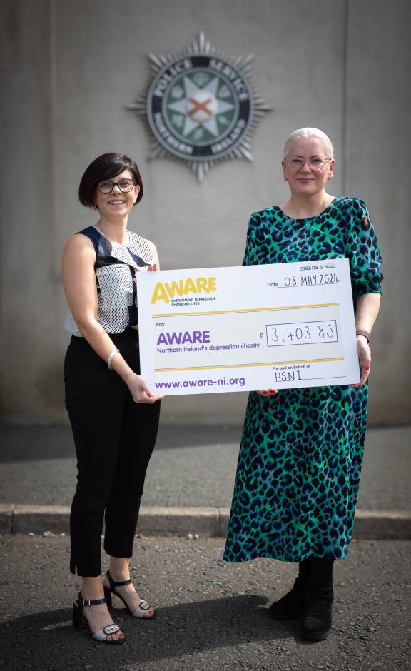 AWARE NI’s Chief Executive Karen Collins is presented with a cheque by Detective Chief Inspector Gail McCormick from the Police Service of Northern Ireland’s Organised Crime Branch for £3,403.85, following a successful recent conviction and the application of a disposal of cash order provided by the courts following a large scale policing operation targeting the supply of drugs.