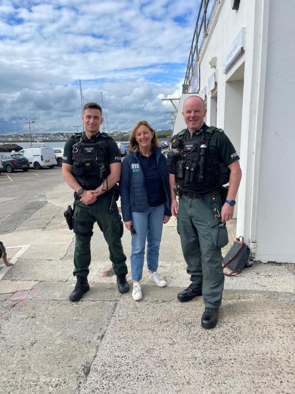 Constables Ben McCandless and John Simpson with Susan McKnight, RYA NI chairperson, at Portrush Yacht Club.