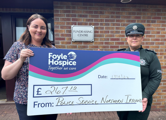 Amy Healy, Foyle Hospice Fundraising and Chief Inspector Siobhan Watt with a cheque for £267. 