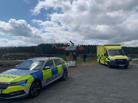 Police vehicle, Coastguard helicopter and ambulance at an incident