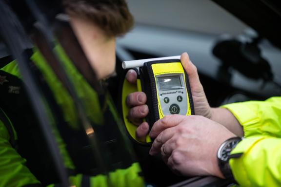 Police officer conducting Breath test at the open window of a vehicle.