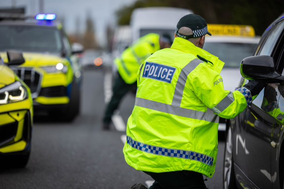 Officers speak to drivers at a vehicle check point