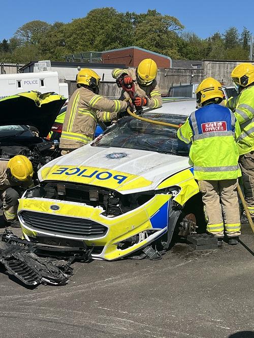 NIFRS work on cutting into armoured police car